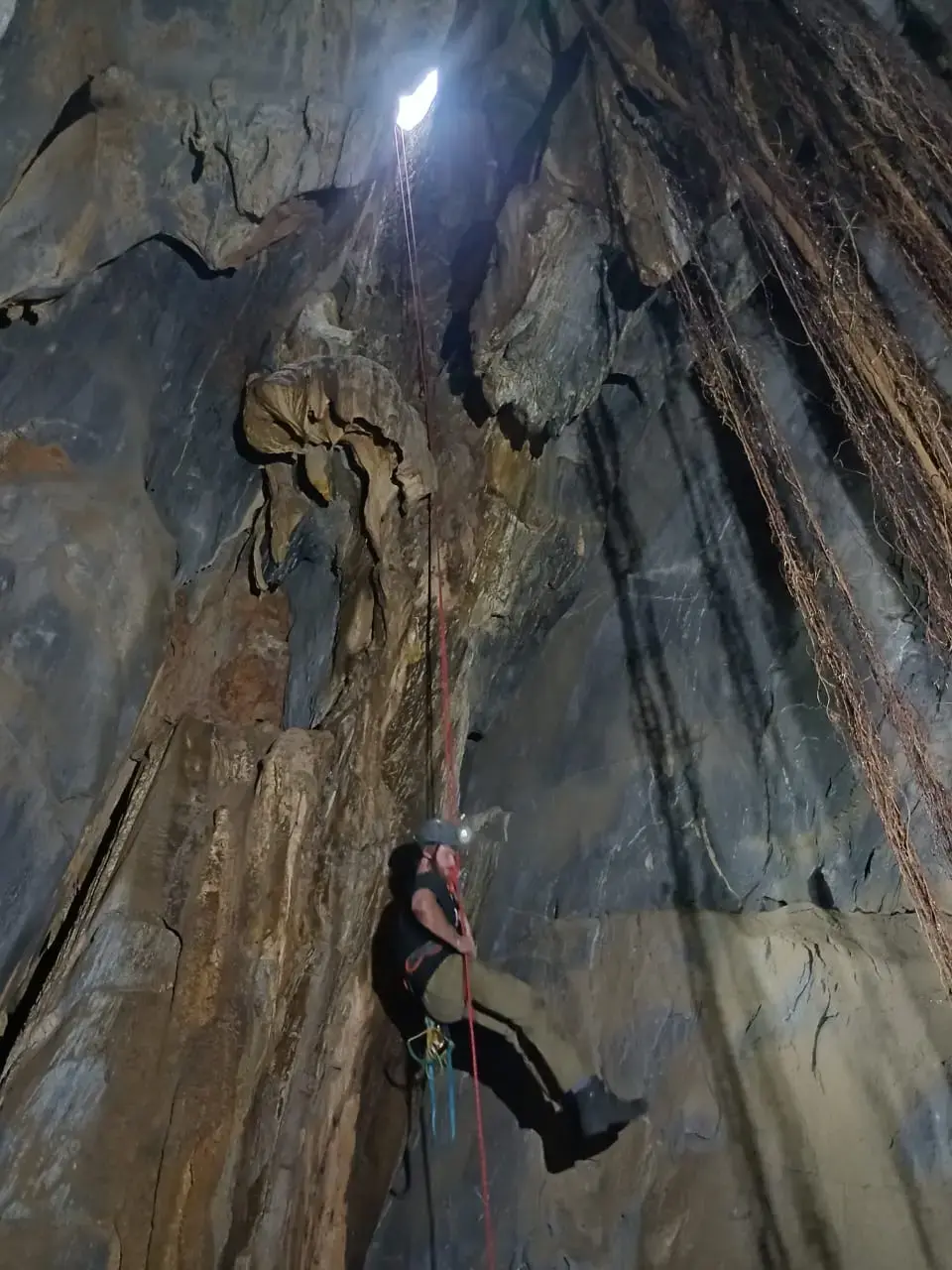 Mathew Paine abseiling into Tripot Cave